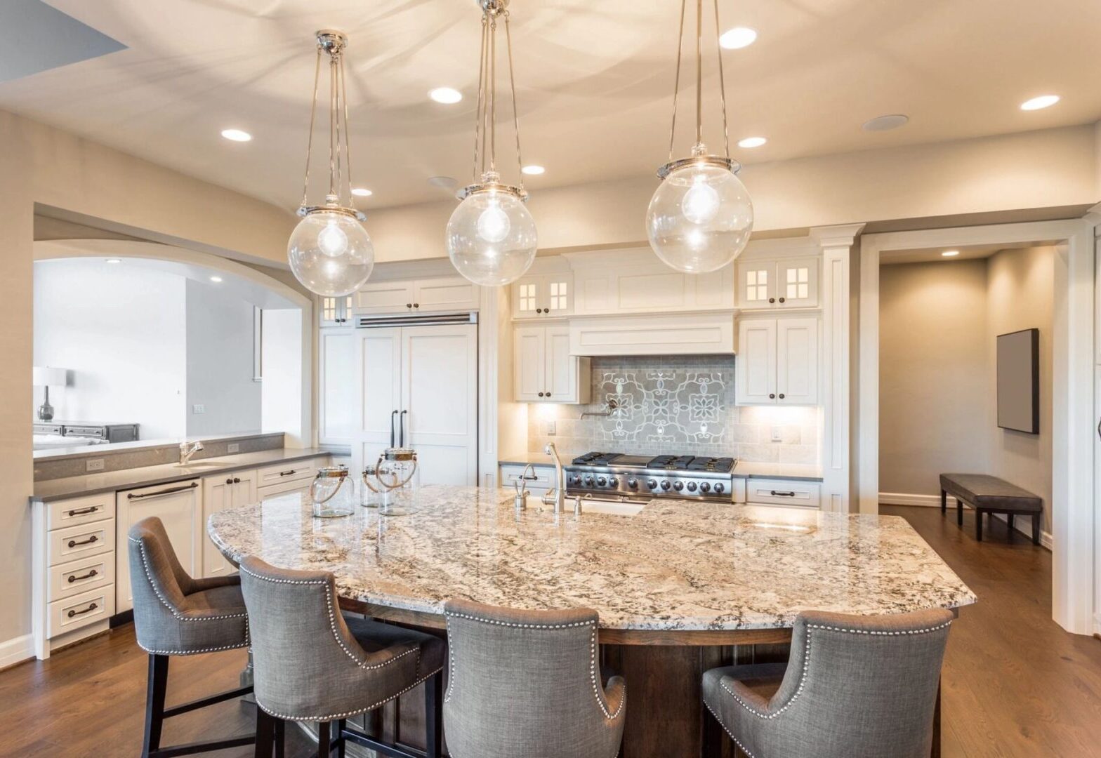 A large kitchen with a round table and chairs