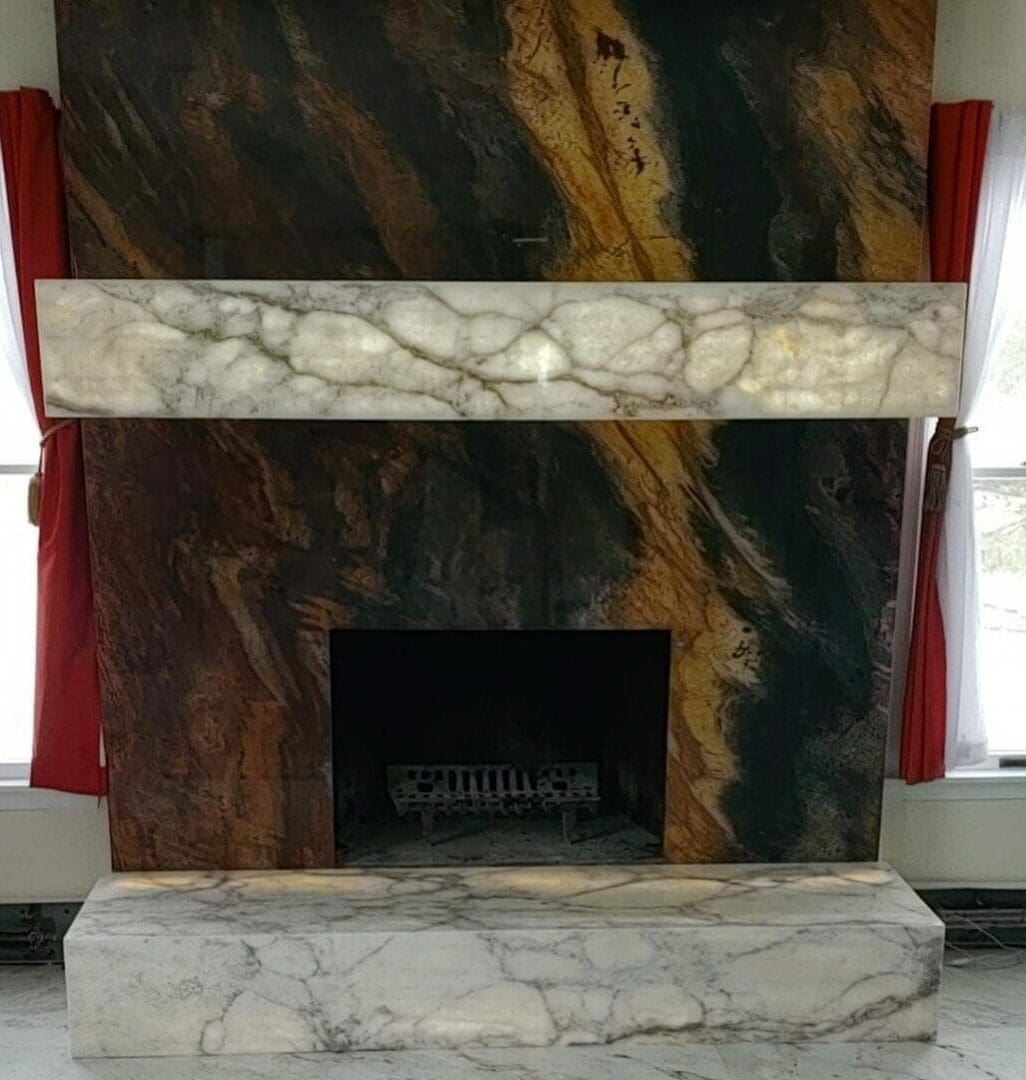 A fireplace with marble and stone in the center.