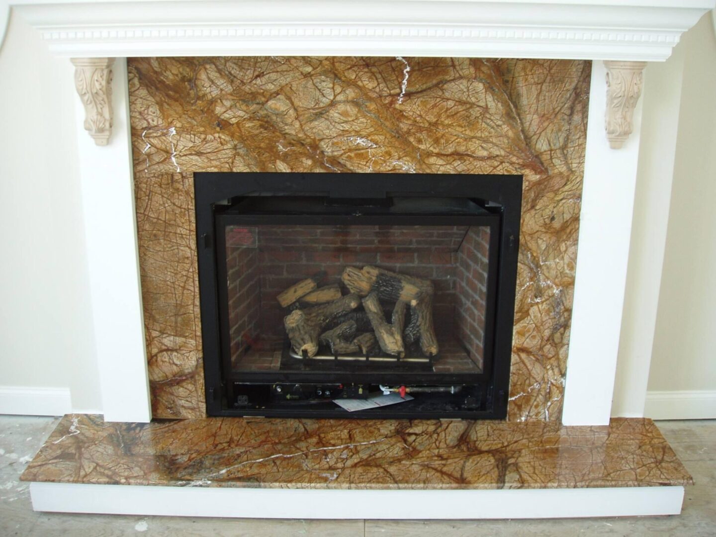 A fireplace with wood burning in it.