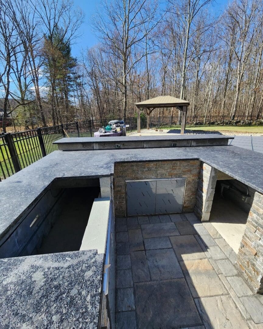 A large outdoor kitchen with an open grill.