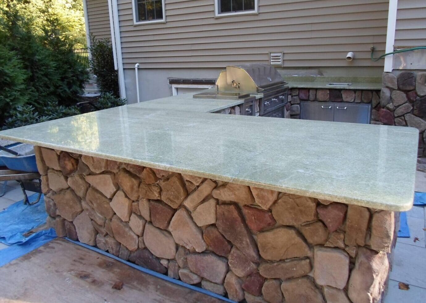 A stone wall with a glass top counter.