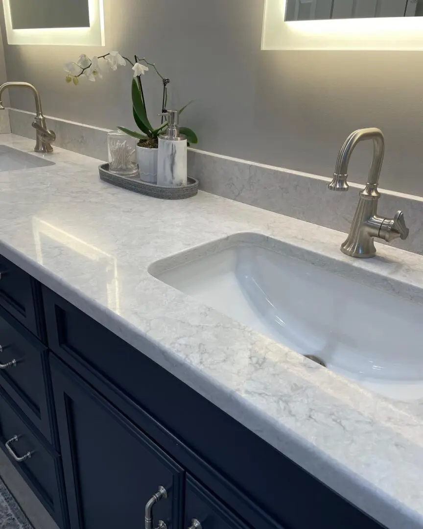 A bathroom with two sinks and a counter top.