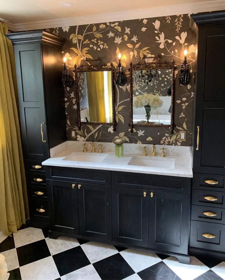 A bathroom with black cabinets and gold fixtures.