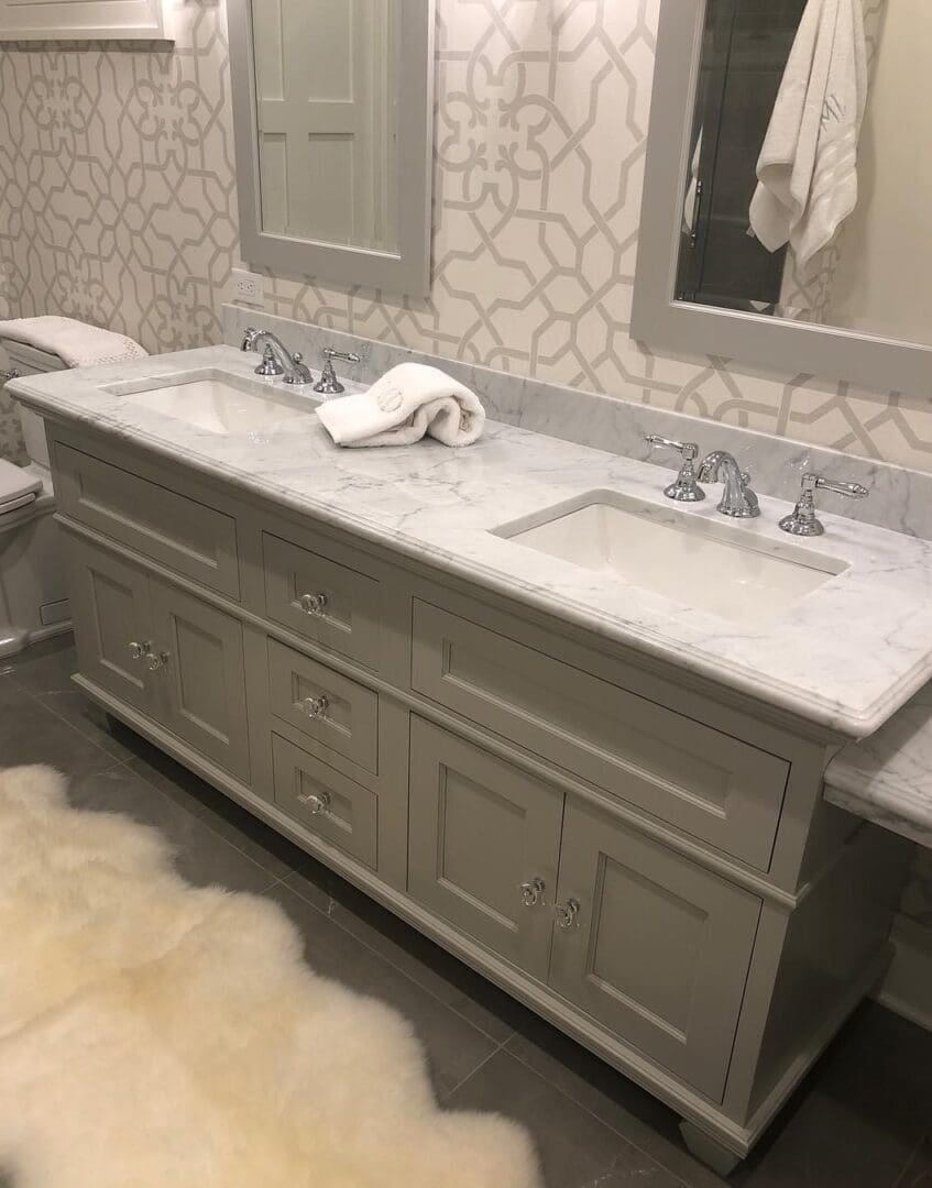 A bathroom with two sinks and a mirror.