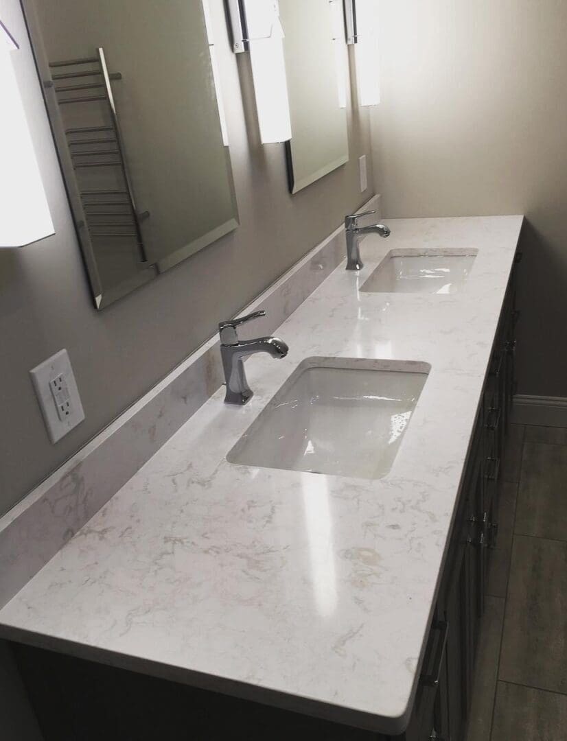 A bathroom with two sinks and mirrors.