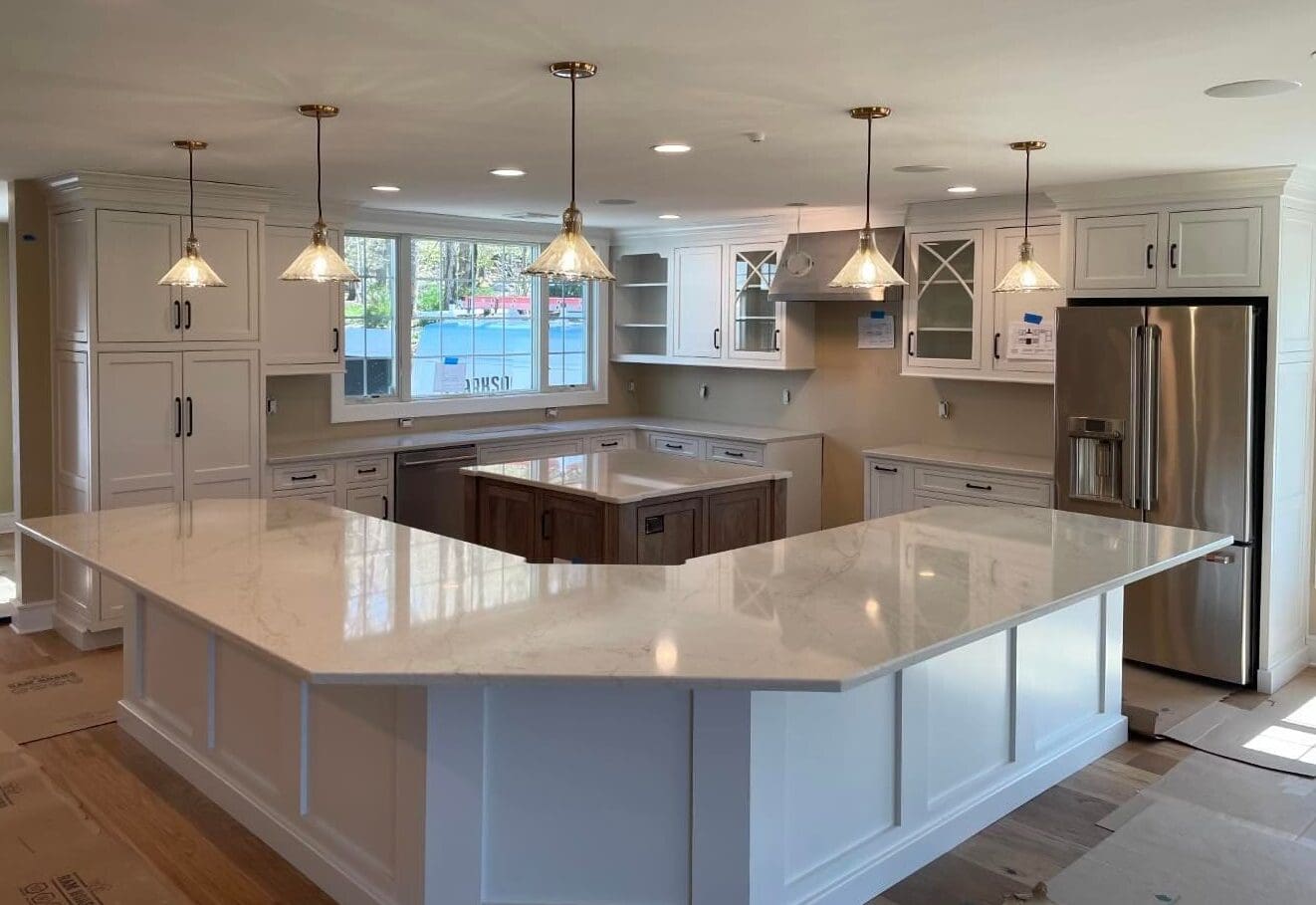 A large kitchen with white cabinets and island.