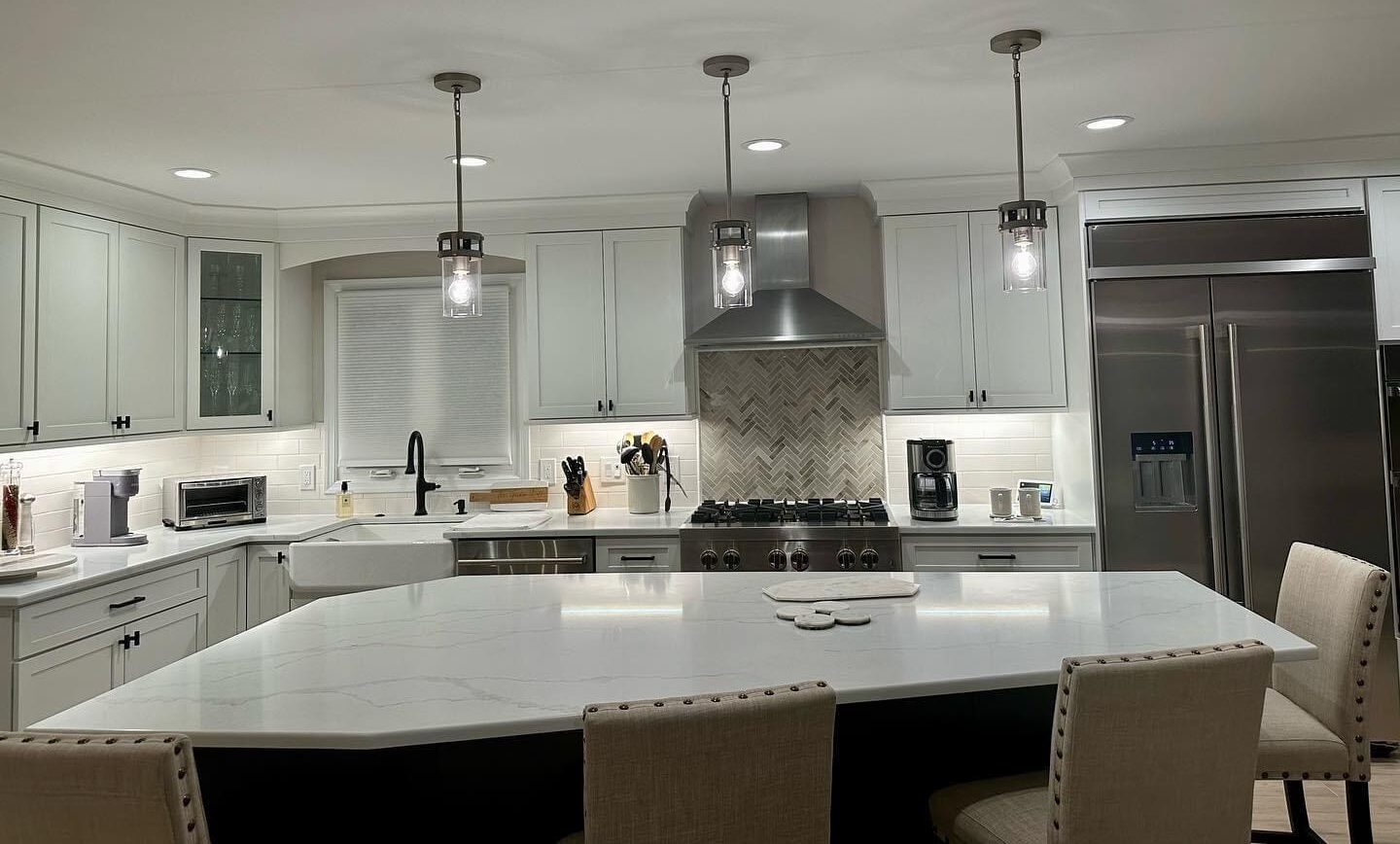 Modern kitchen with white cabinets and island.