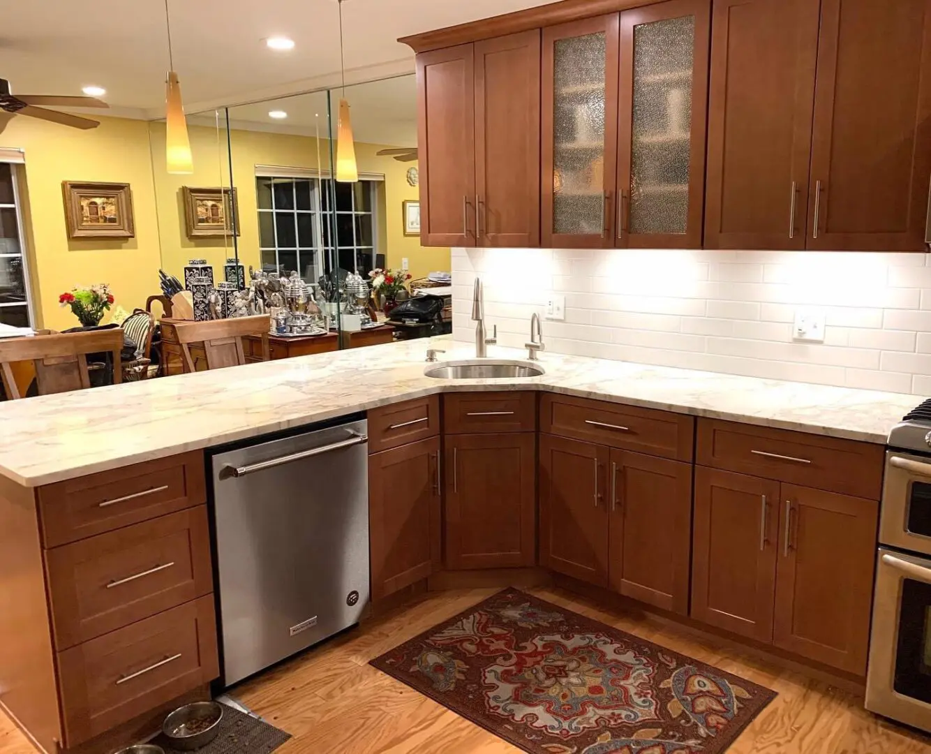 Modern kitchen with wood cabinets and white tile.