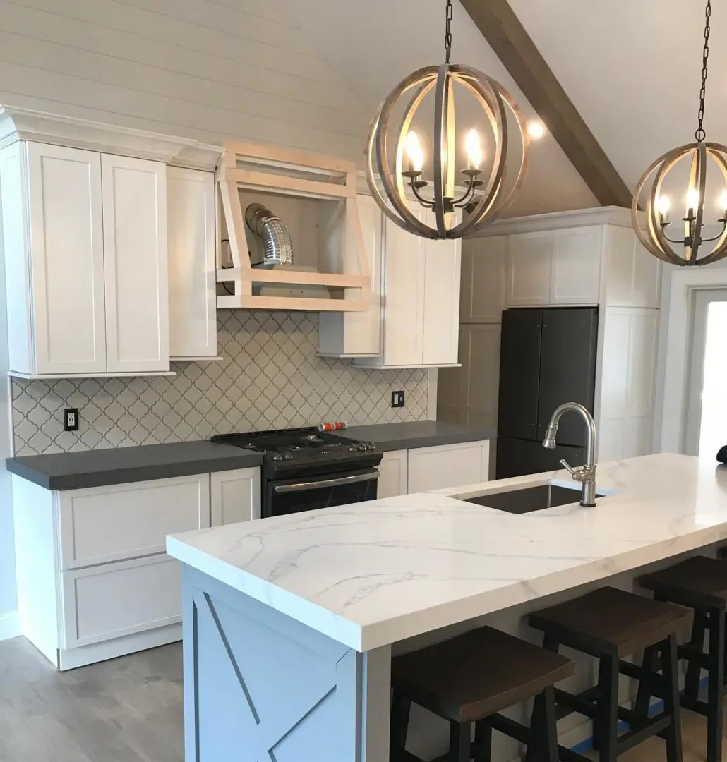 White kitchen island with marble countertop.