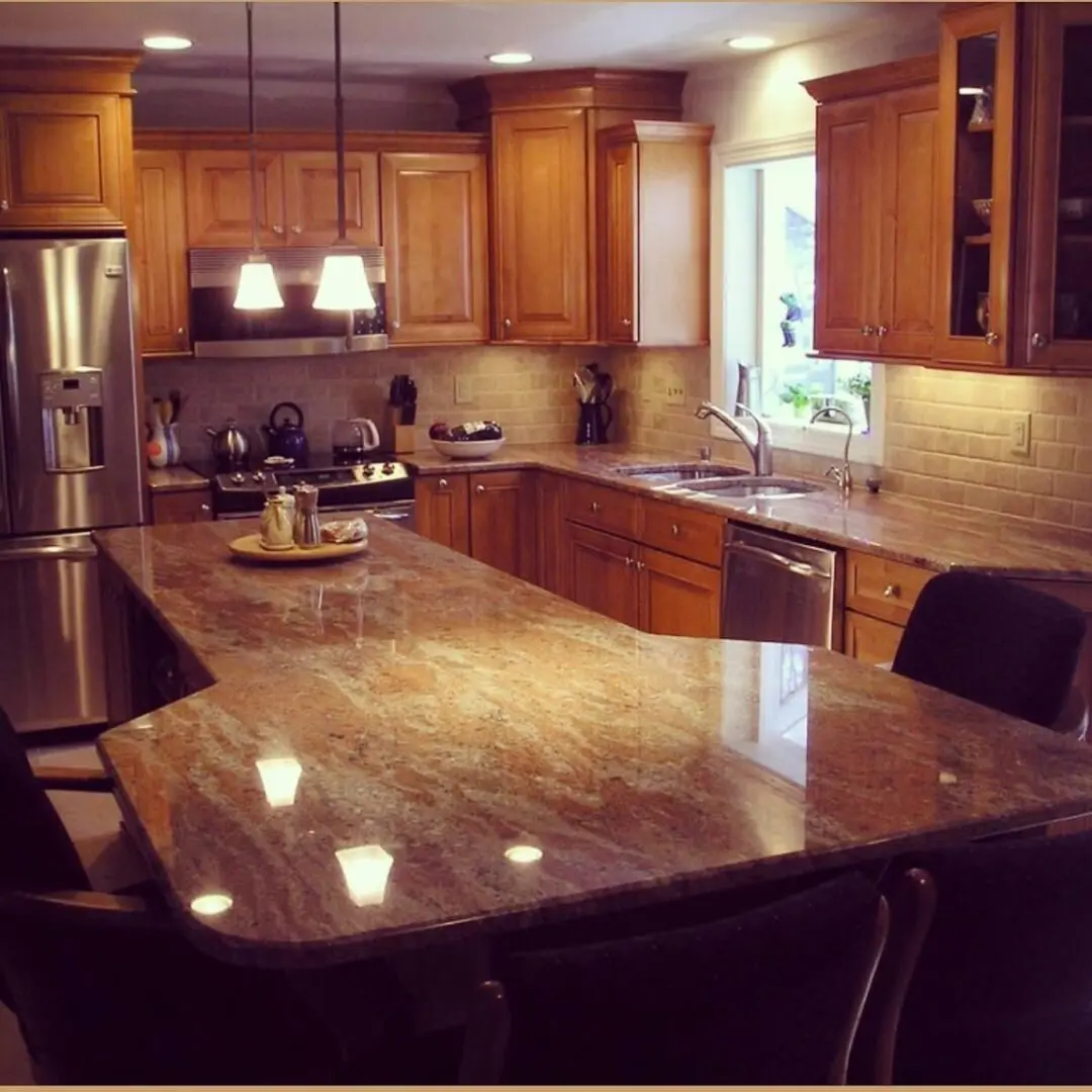 A kitchen with wooden cabinets and granite counter tops.