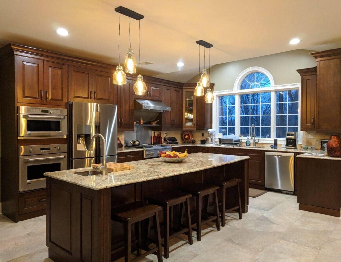 A kitchen with brown cabinets and stainless steel appliances.