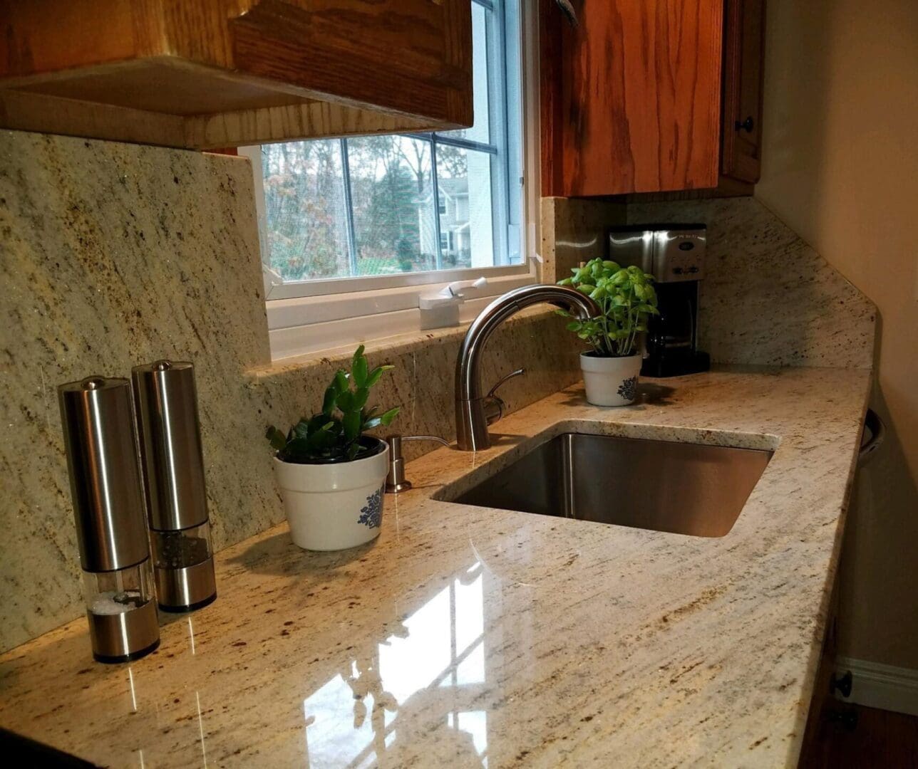 A kitchen with granite counter tops and stainless steel appliances.