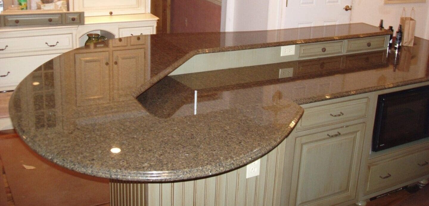 A counter with a mirror on it and some cabinets