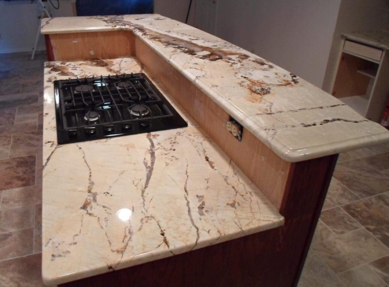 A marble counter top with an oven and sink.