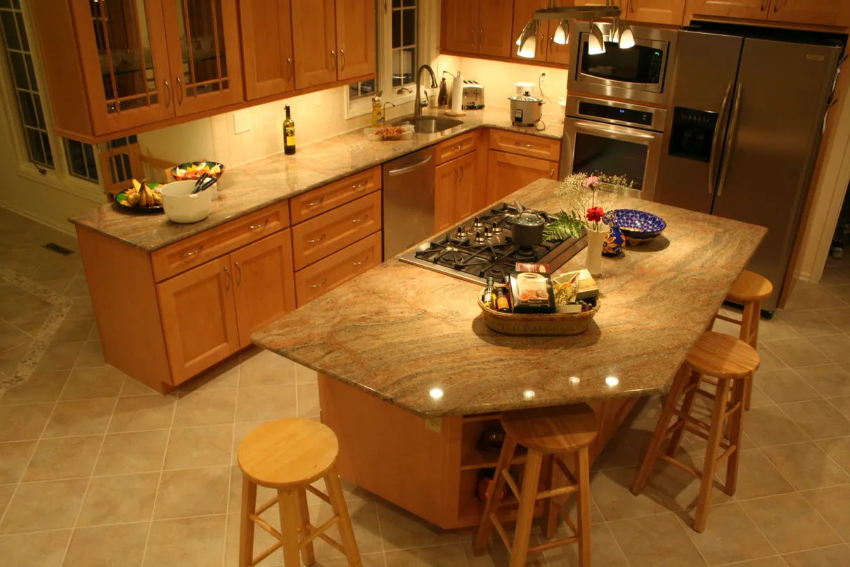 Kitchen island with granite countertop and stools.