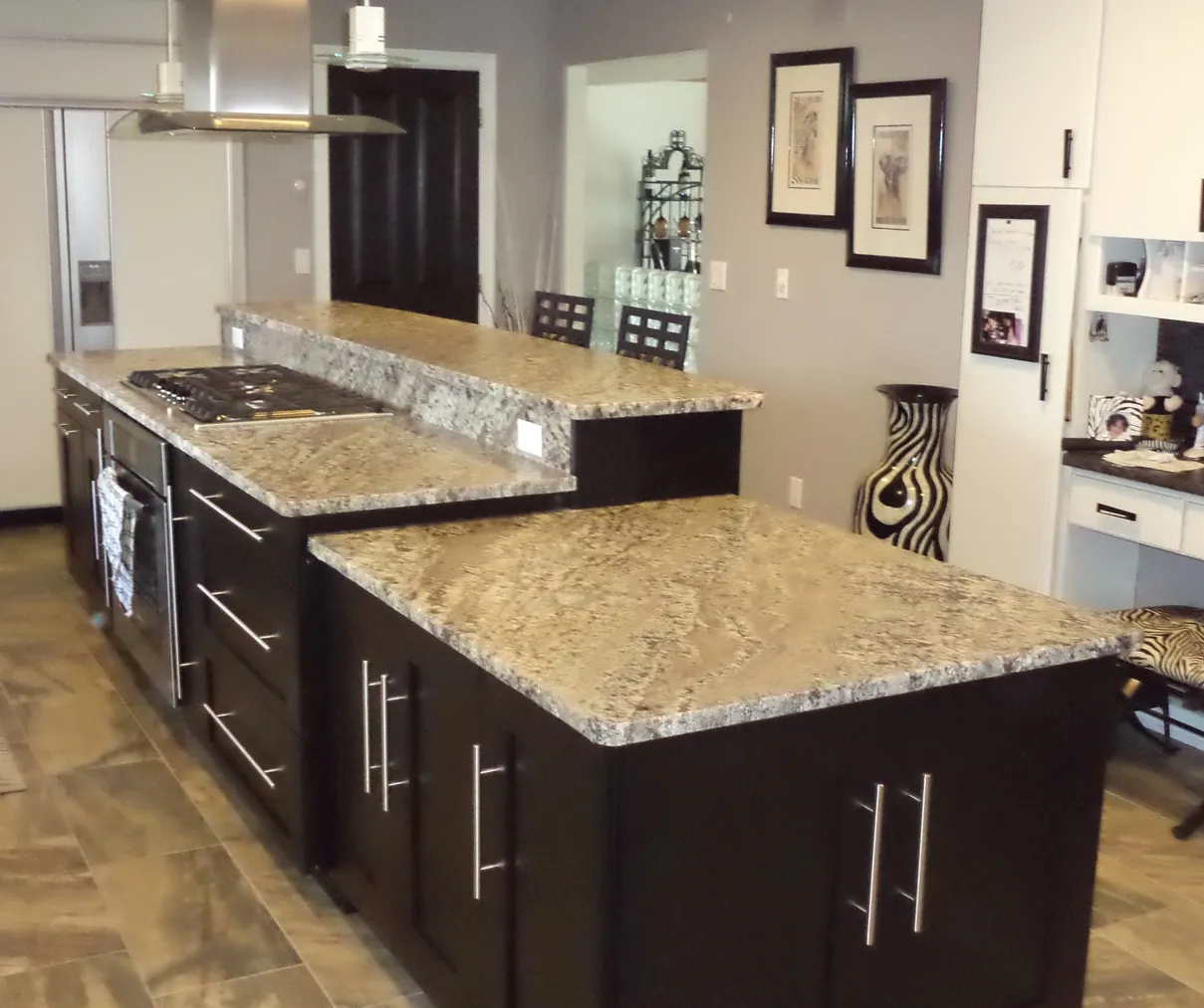 Black kitchen island with granite countertop.