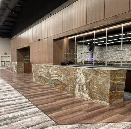 A large marble bar in the middle of an indoor area.