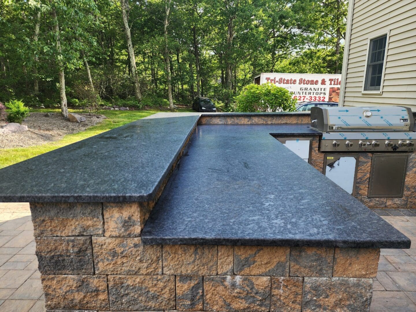 A black granite counter top on the side of a building.