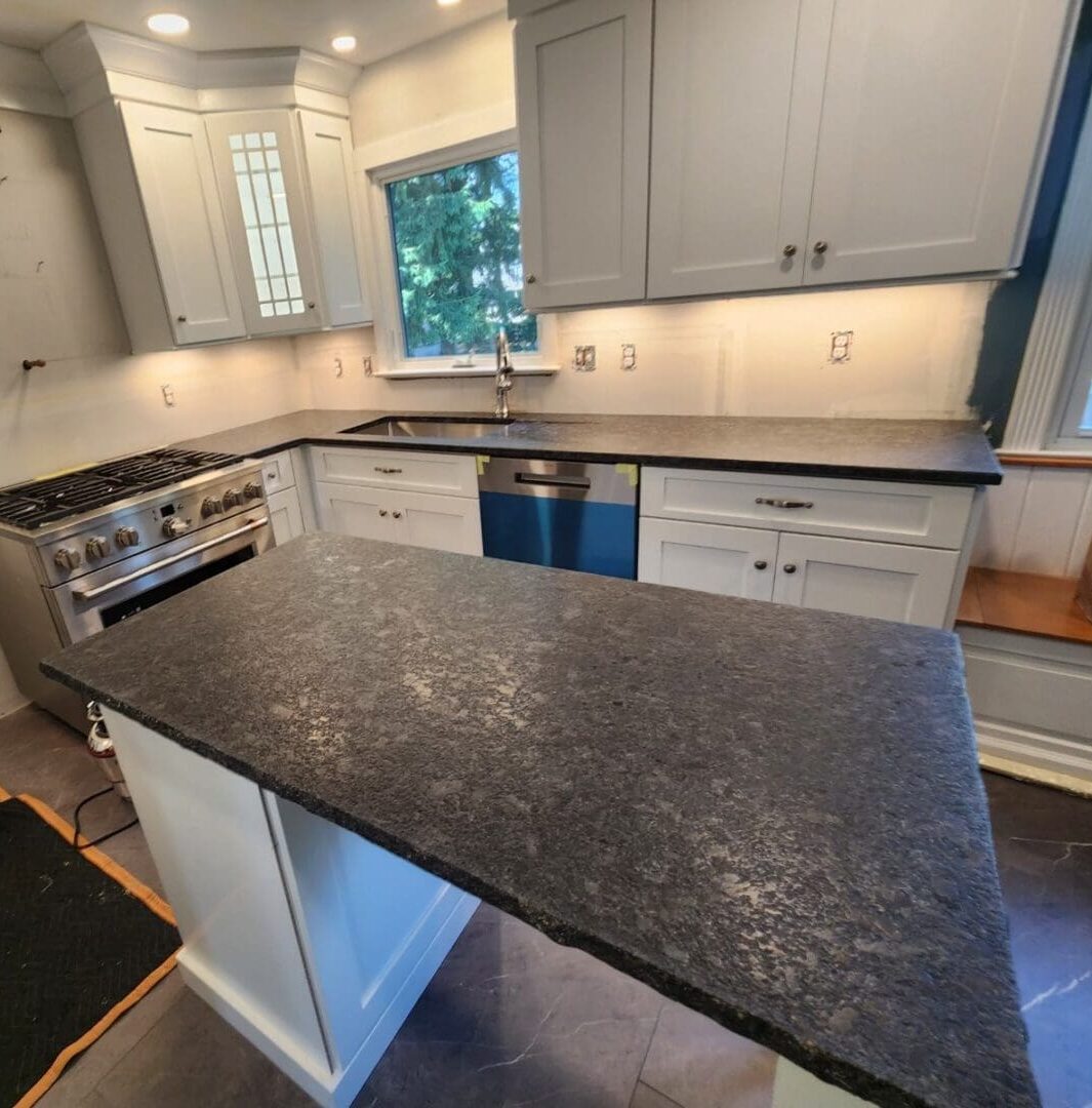 Kitchen island with black granite countertop.