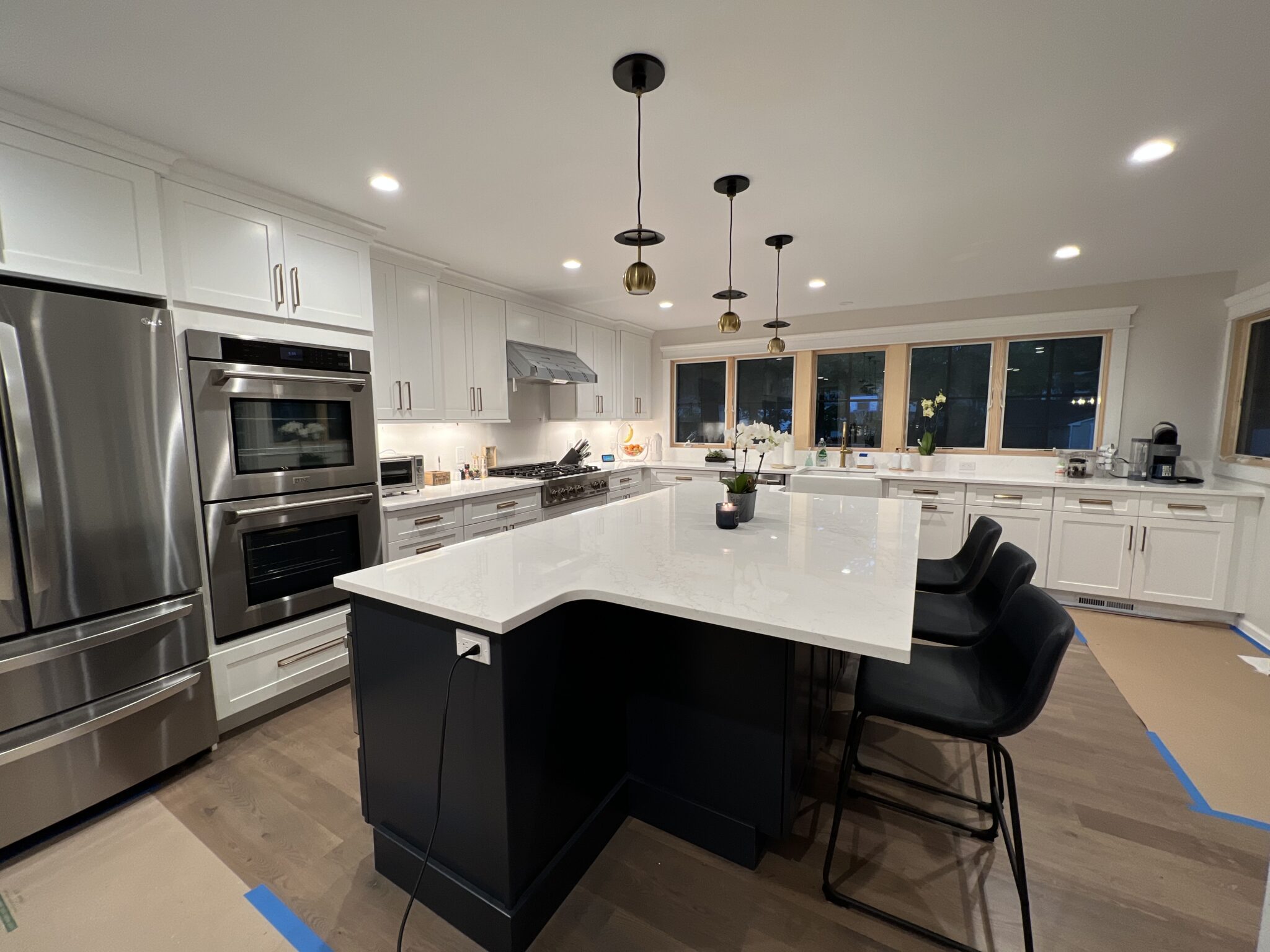 A large kitchen with an island and white cabinets.