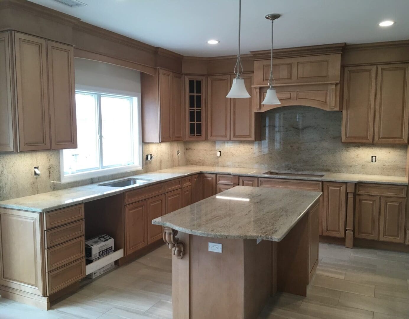 A kitchen with wooden cabinets and granite counter tops.