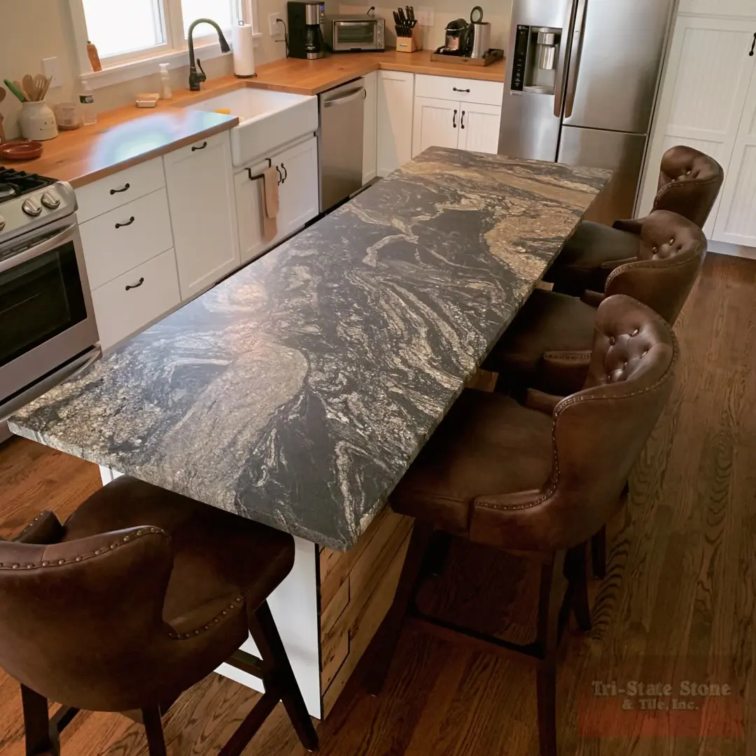 A kitchen with a table and chairs in it