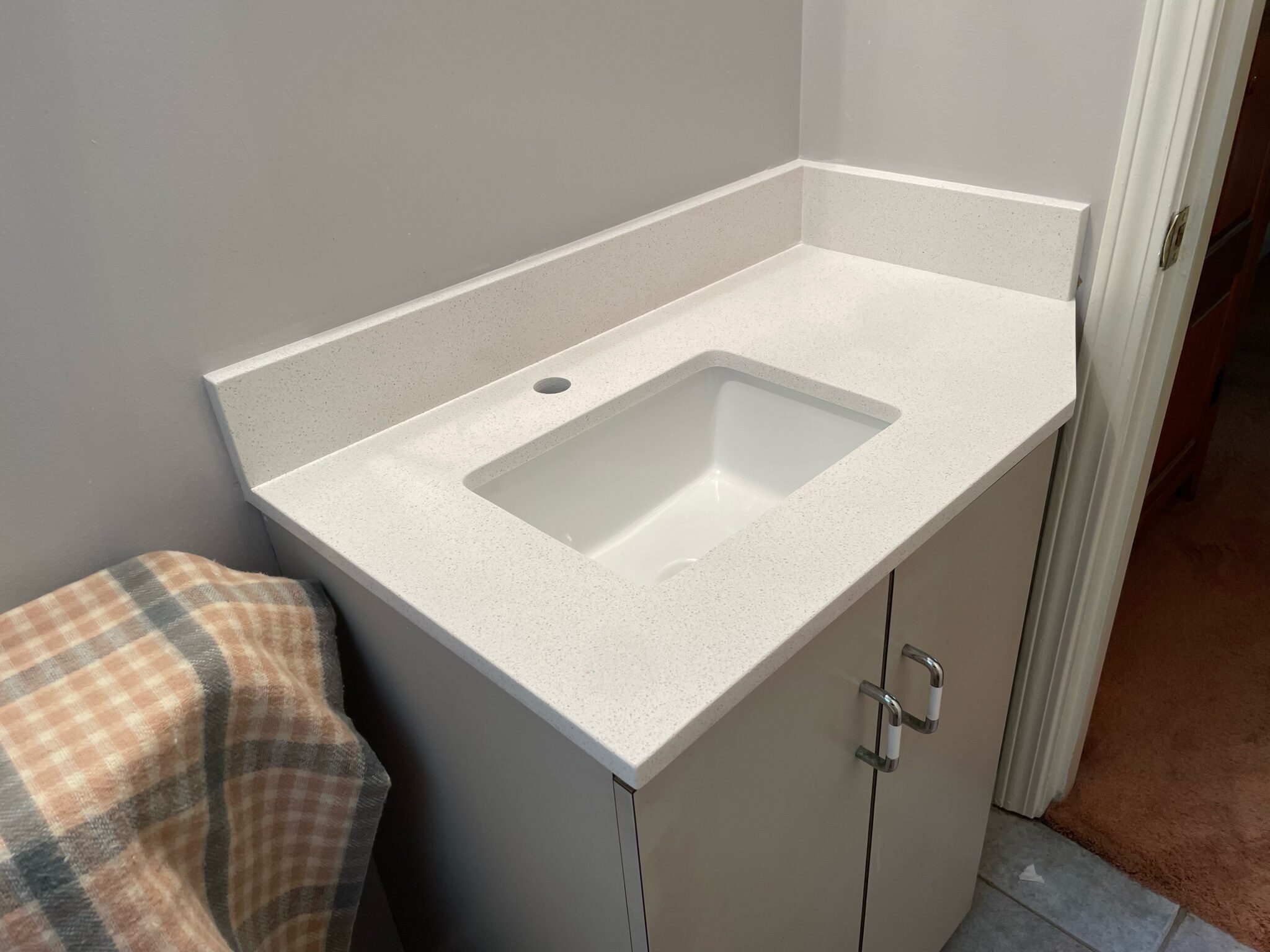 A white sink sitting in the middle of a bathroom.