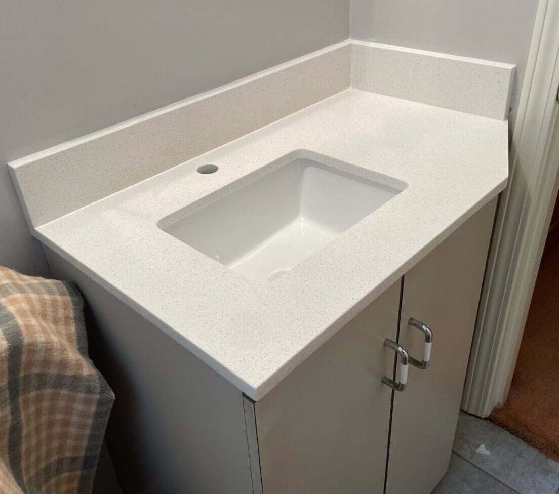 A white sink sitting in the middle of a bathroom.