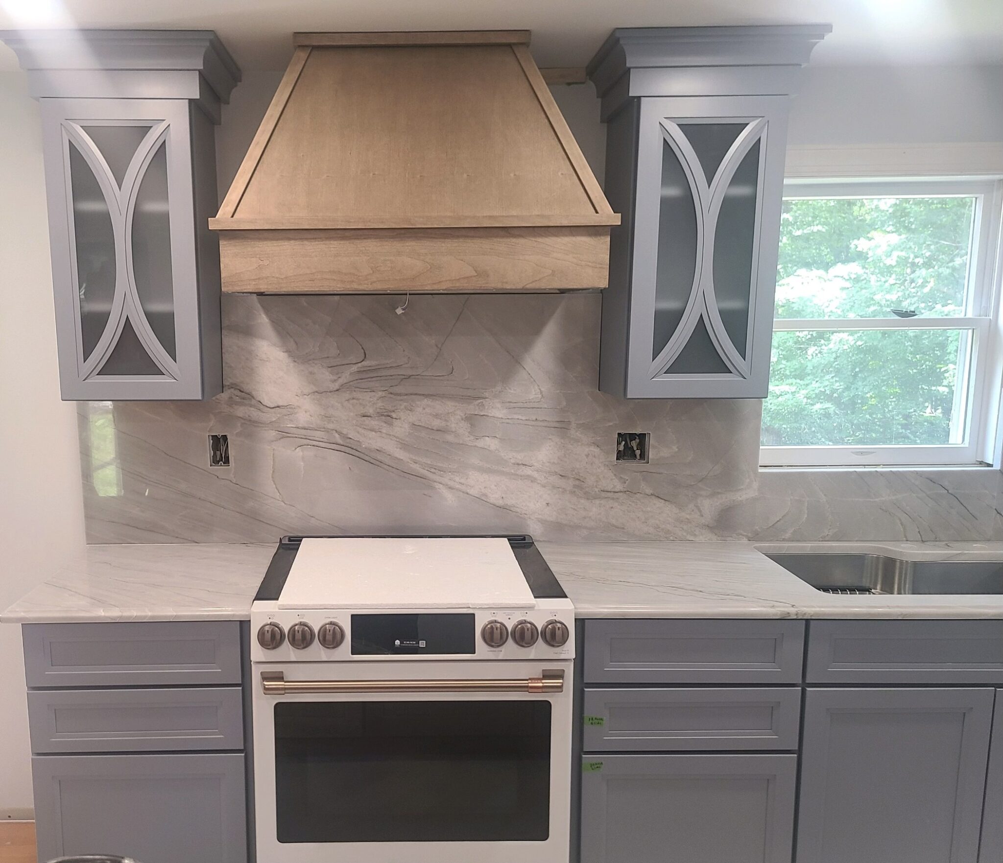 Kitchen with new stove and cabinets.