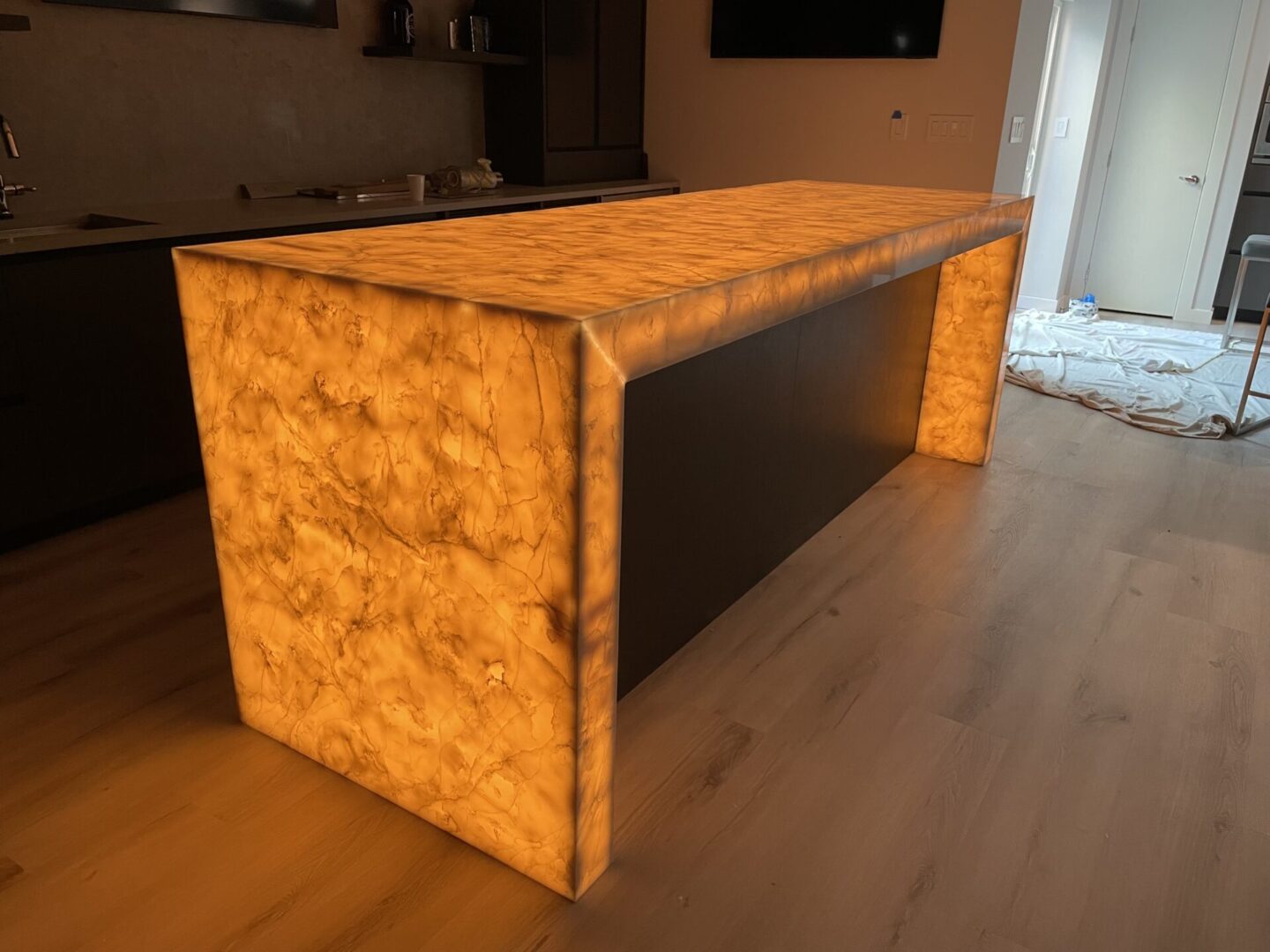 Backlit kitchen island with marble countertop.