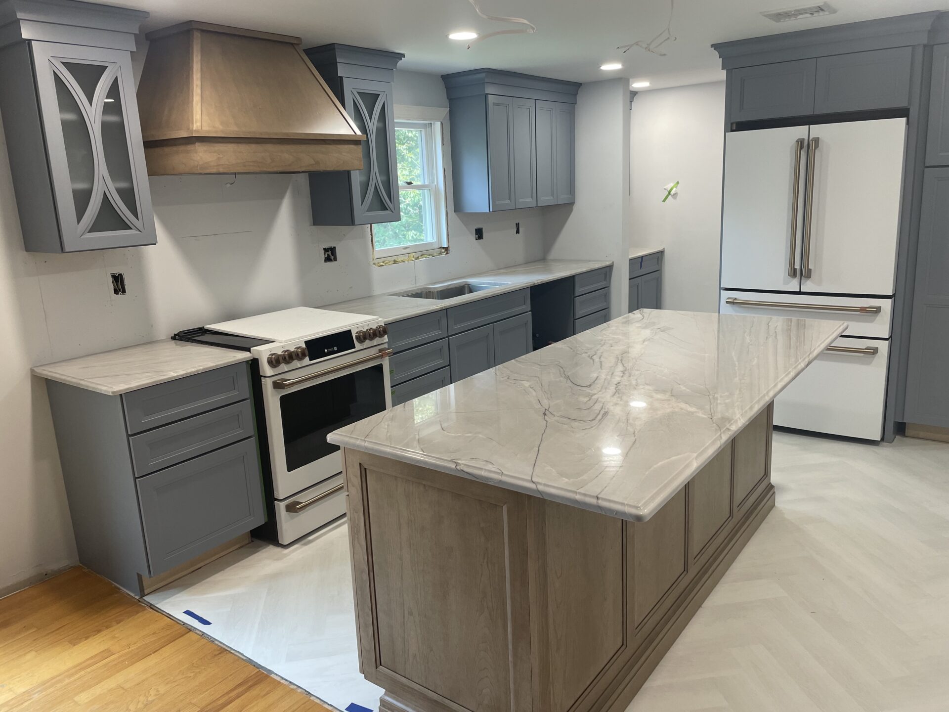 Modern kitchen with gray cabinets and island.