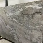 Stacked slabs of brown and gray marble.