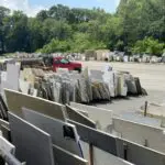 Stacked granite slabs for sale outdoors.