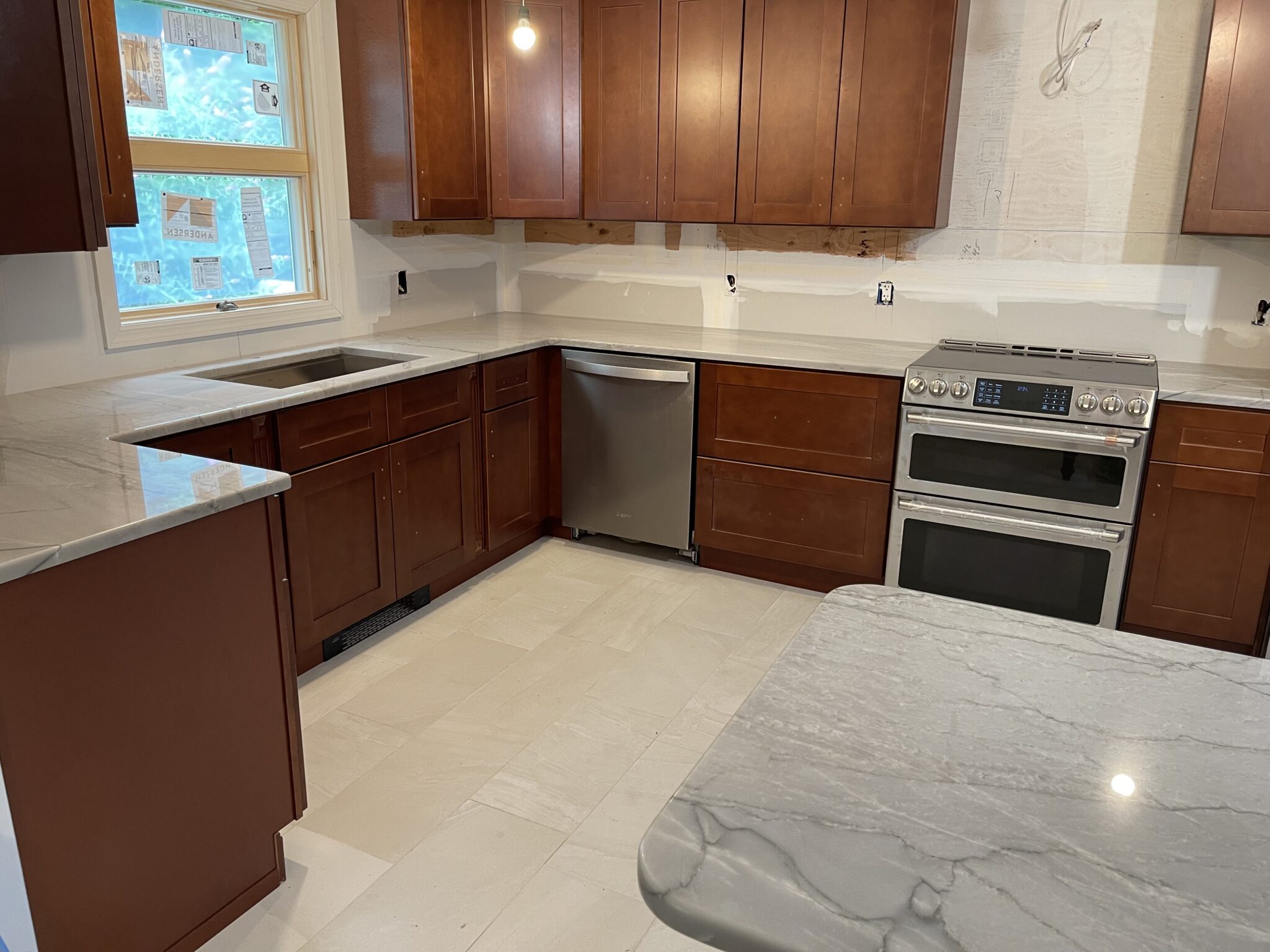 Modern kitchen with white quartz countertops.