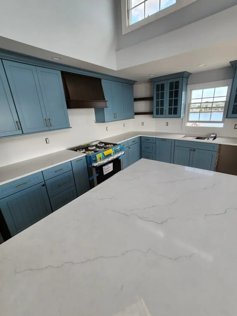 White countertop in a blue kitchen.