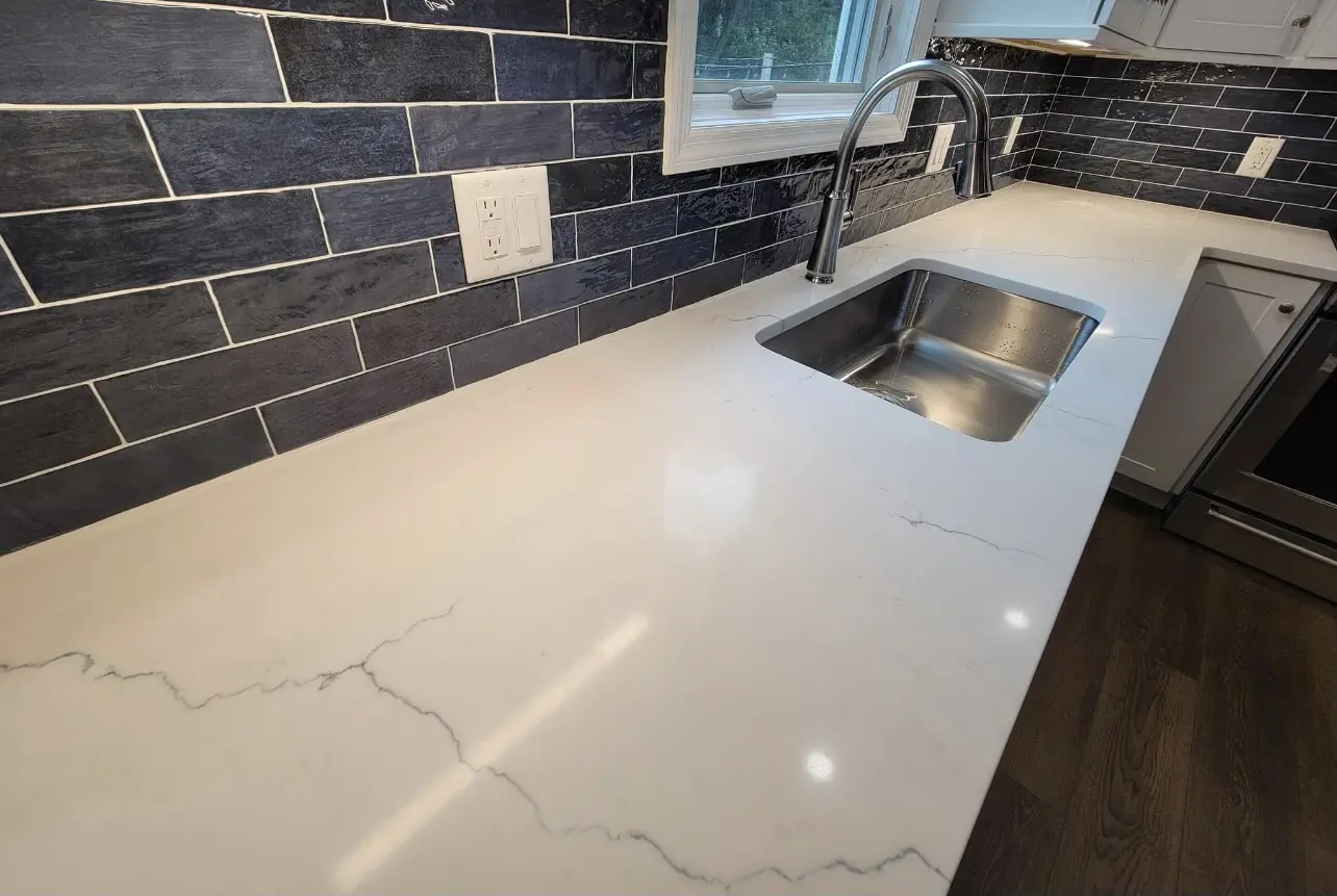 White kitchen counter with a sink.