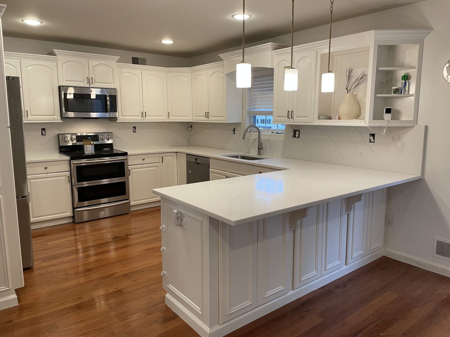 White kitchen with white cabinets and island.