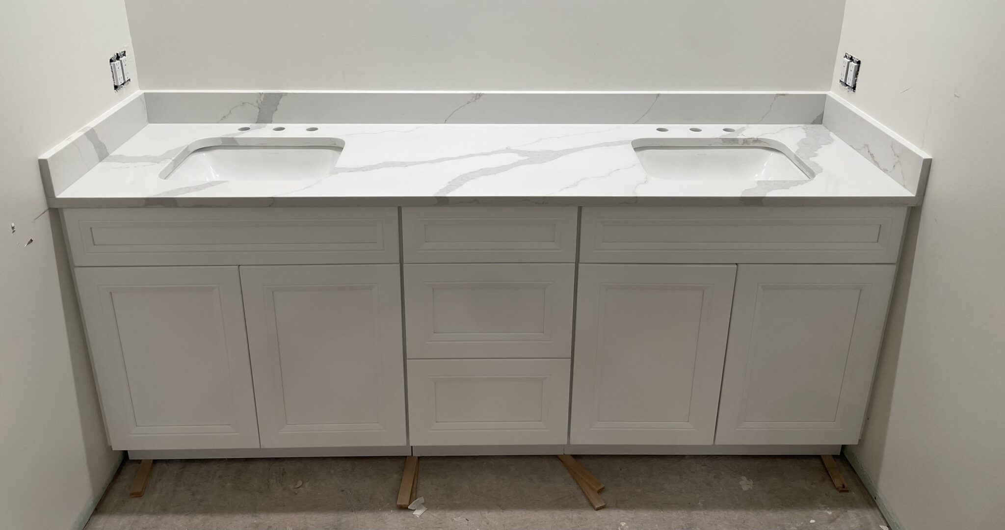 White bathroom vanity with double sinks.