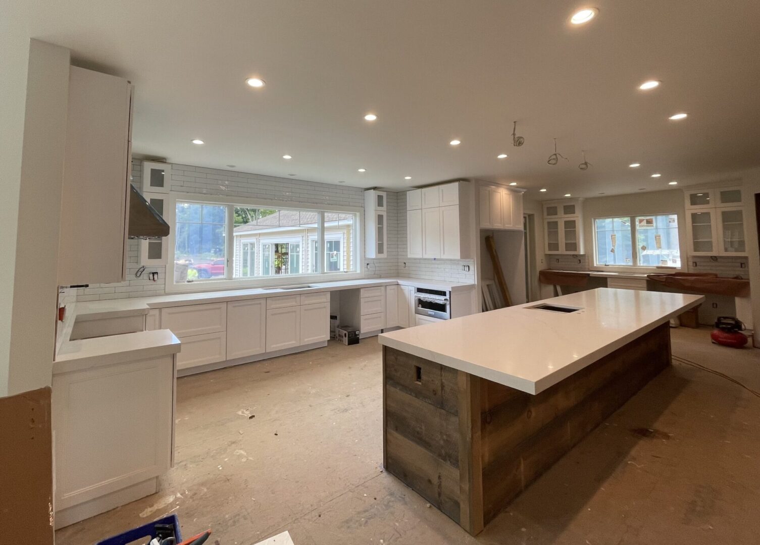 Modern kitchen with white cabinets and island.