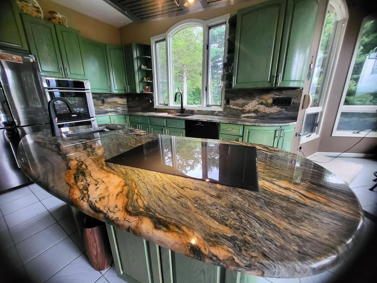 Kitchen island with granite countertop and stovetop.