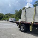 Large slab of granite on flatbed truck.