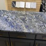 Blue granite countertop on dark cabinets.