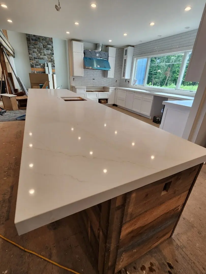 White countertop with wood base in kitchen.