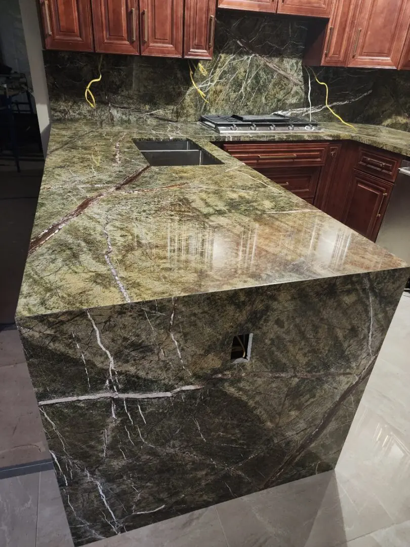 Green marble kitchen countertop with sink.