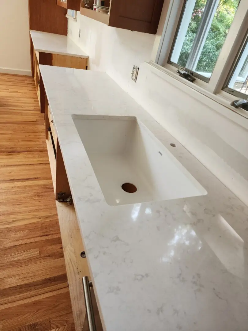 White kitchen countertop with sink.