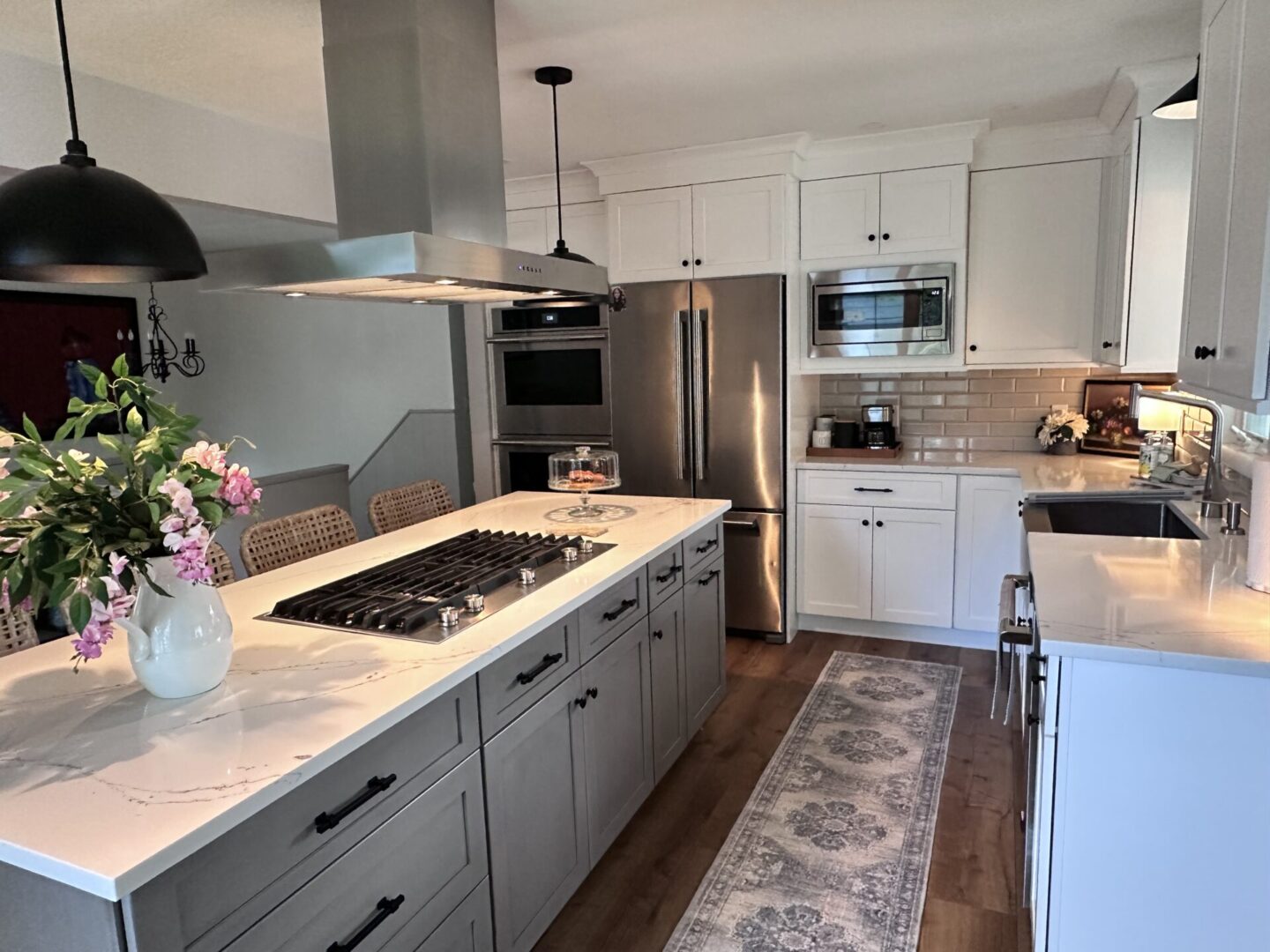 Modern kitchen island with white cabinets.