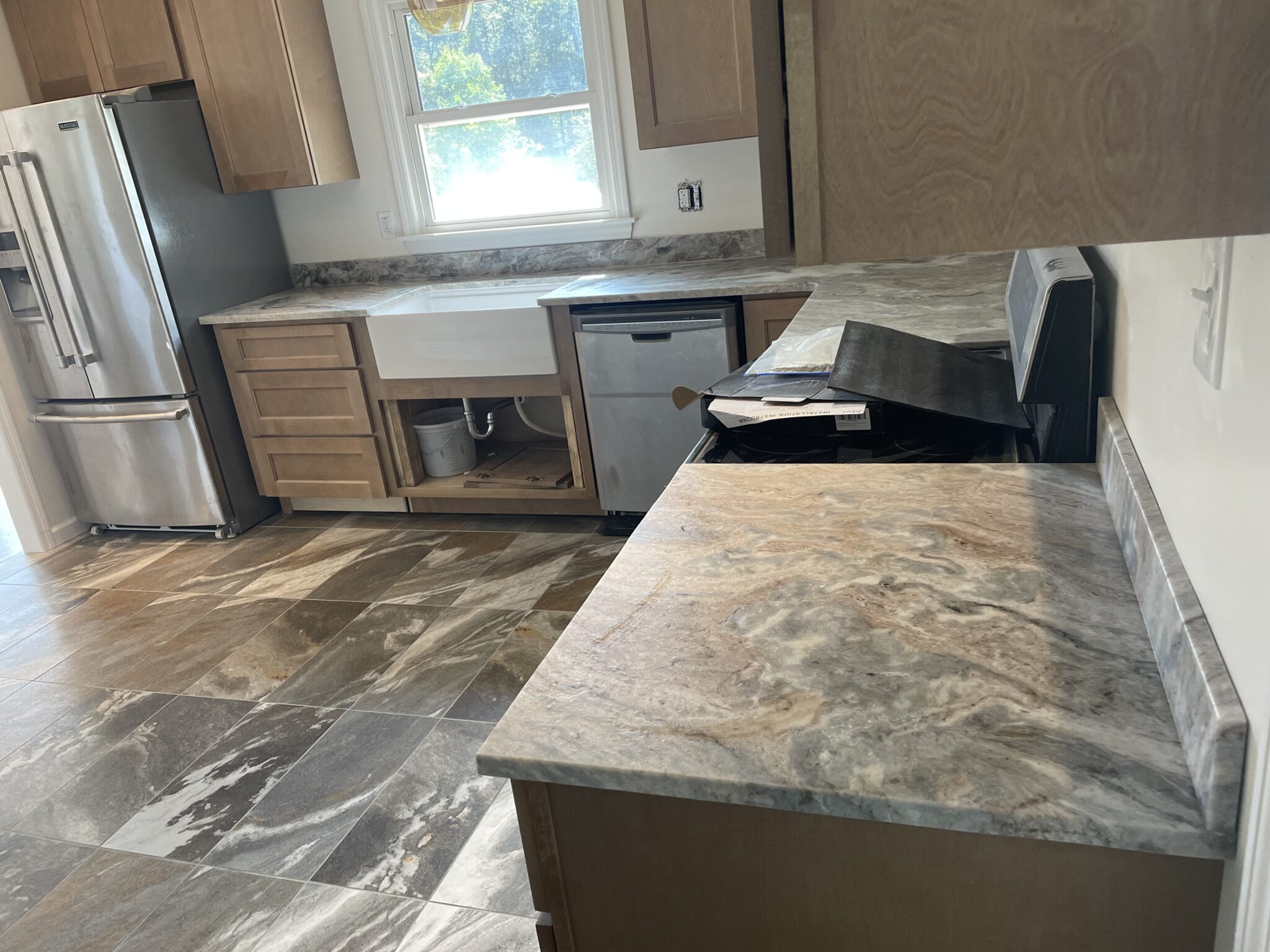 Kitchen with new countertops and tile.