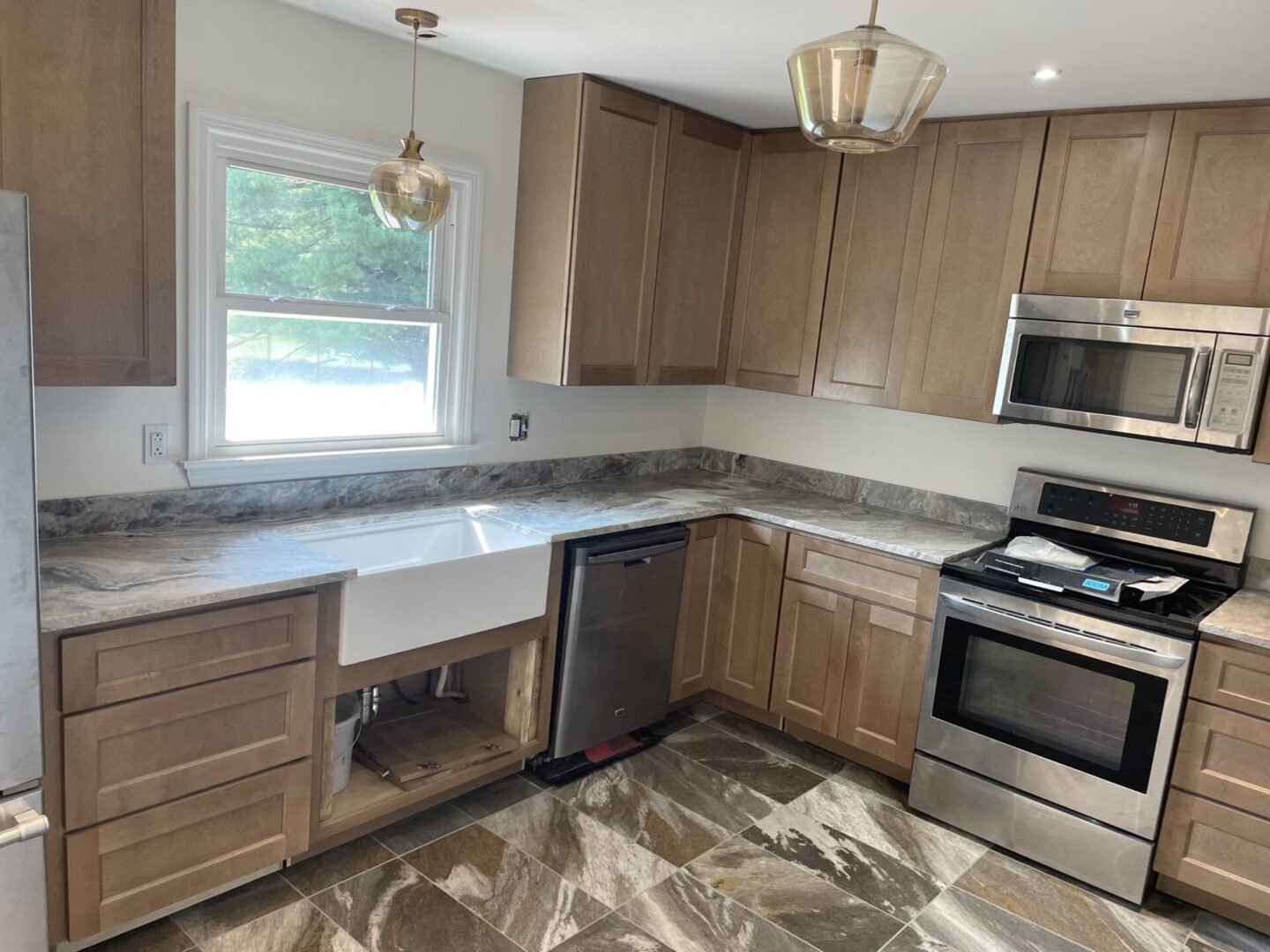 Kitchen with white sink and granite counters.