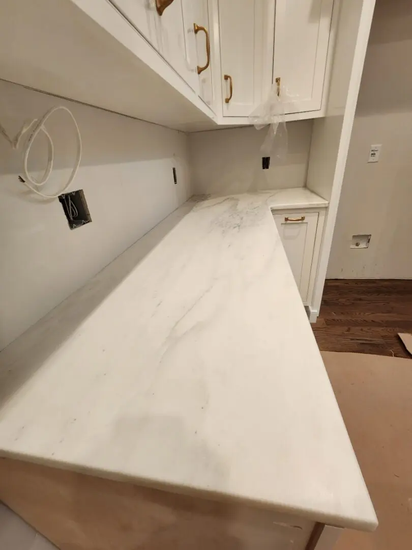 White marble countertop in a kitchen.