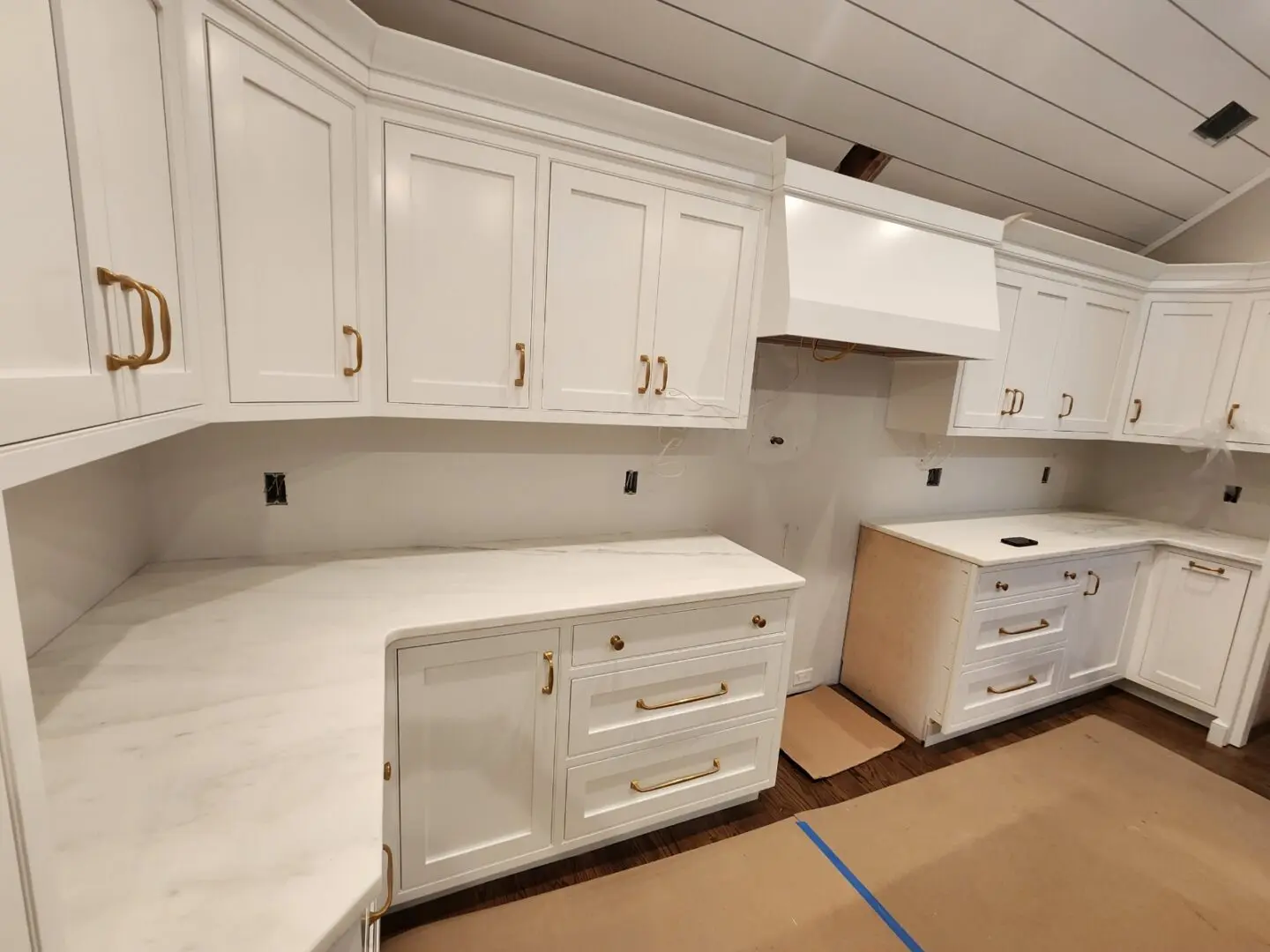 White kitchen cabinets with gold hardware.